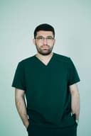 Portrait of a male nurse in blue scrubs